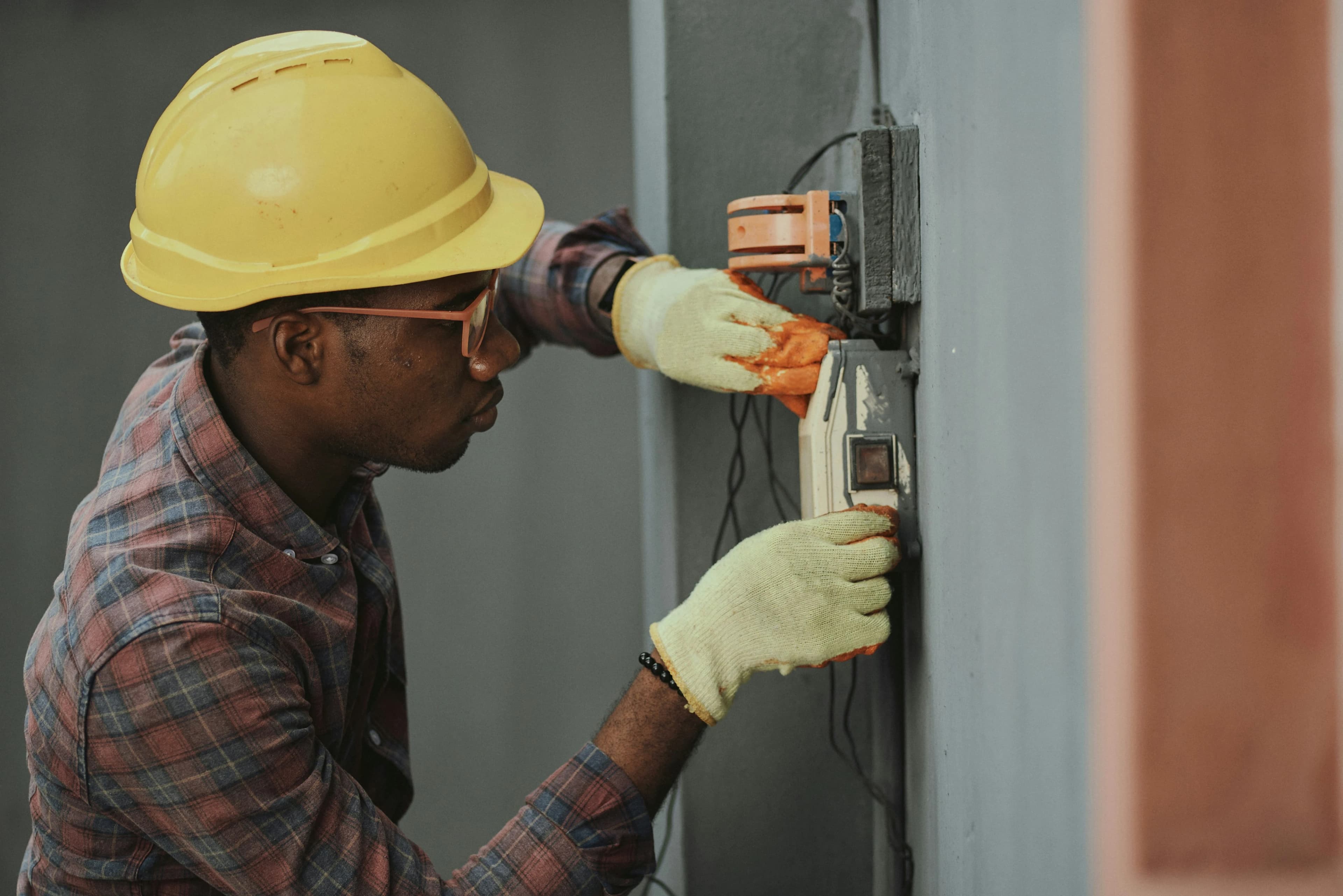 man repairing electric outlet